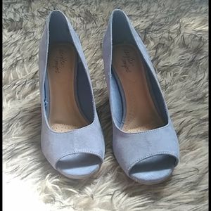 A light blue open toe wedge shoe